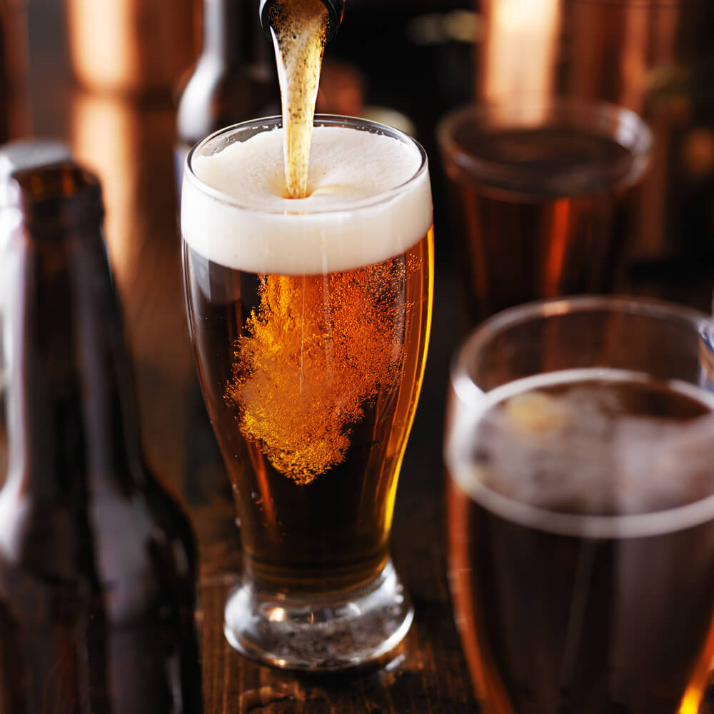 pouring-beer-into-glass-on-wooden-table-2025-04-02-16-56-00-utc (1)