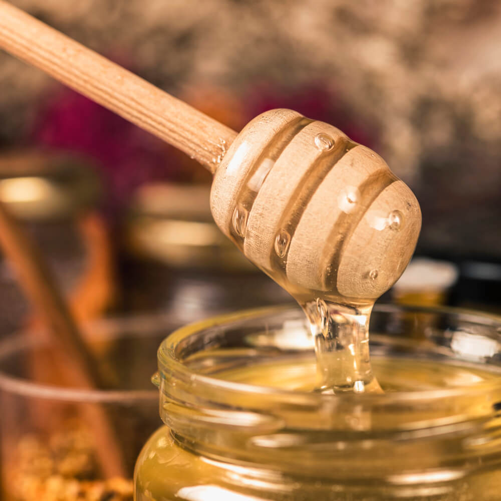 wooden-dipper-with-flowing-honey-2024-10-21-05-21-55-utc